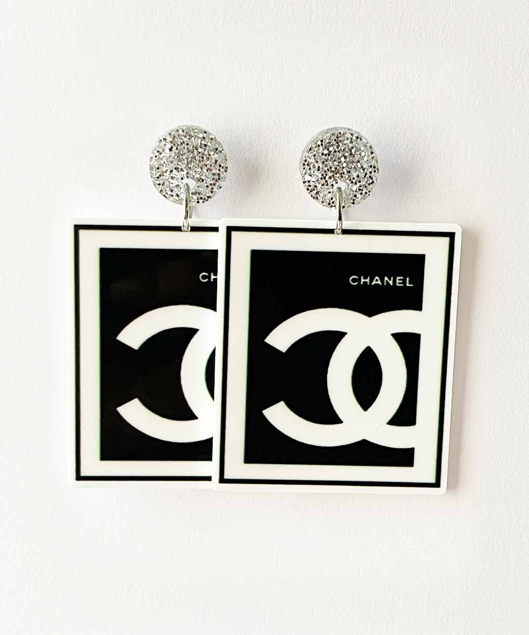 These Chanel CC-inspired earrings capture the essence of timeless luxury and sophisticated style.
